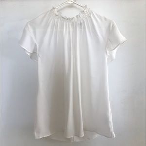 Never wore white blouse. Ruffle neck.